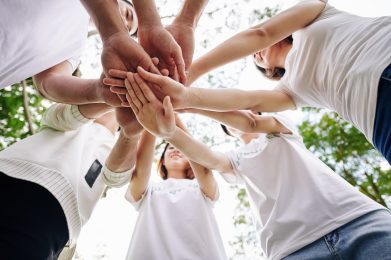 volunteers stacking hands to show teamwork