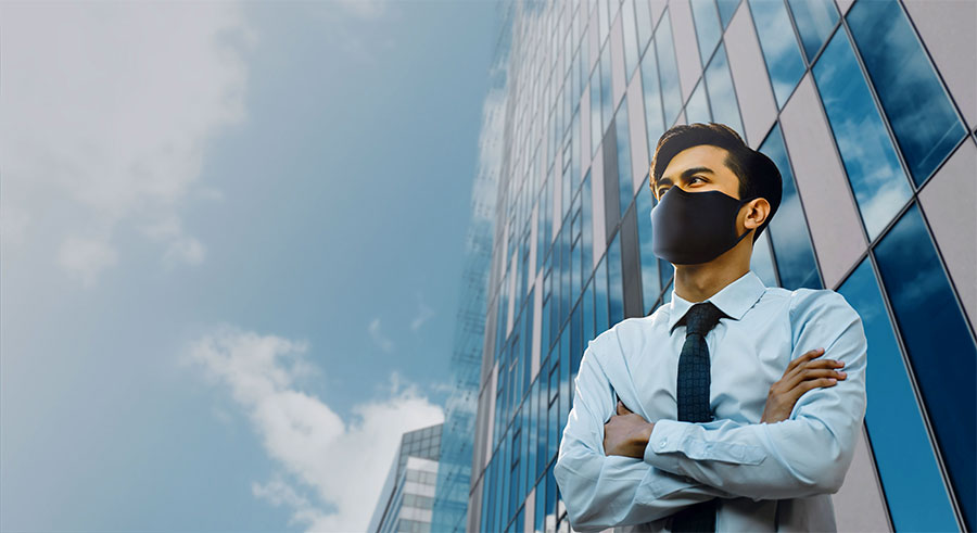Man in mask outside of building
