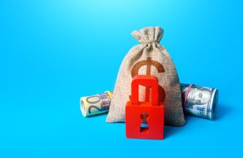 Dollar money bag and red padlock. Sanctions and Restrictions. Freezing of assets, seizure of savings and property. Unavailability of loans, low credit score. Fund reservation. Transaction restrictions