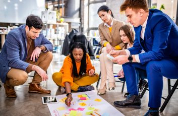 Project managers and employees brainstorming on ideas - Multi-ethnic group of workers having business meeting in a start-up office